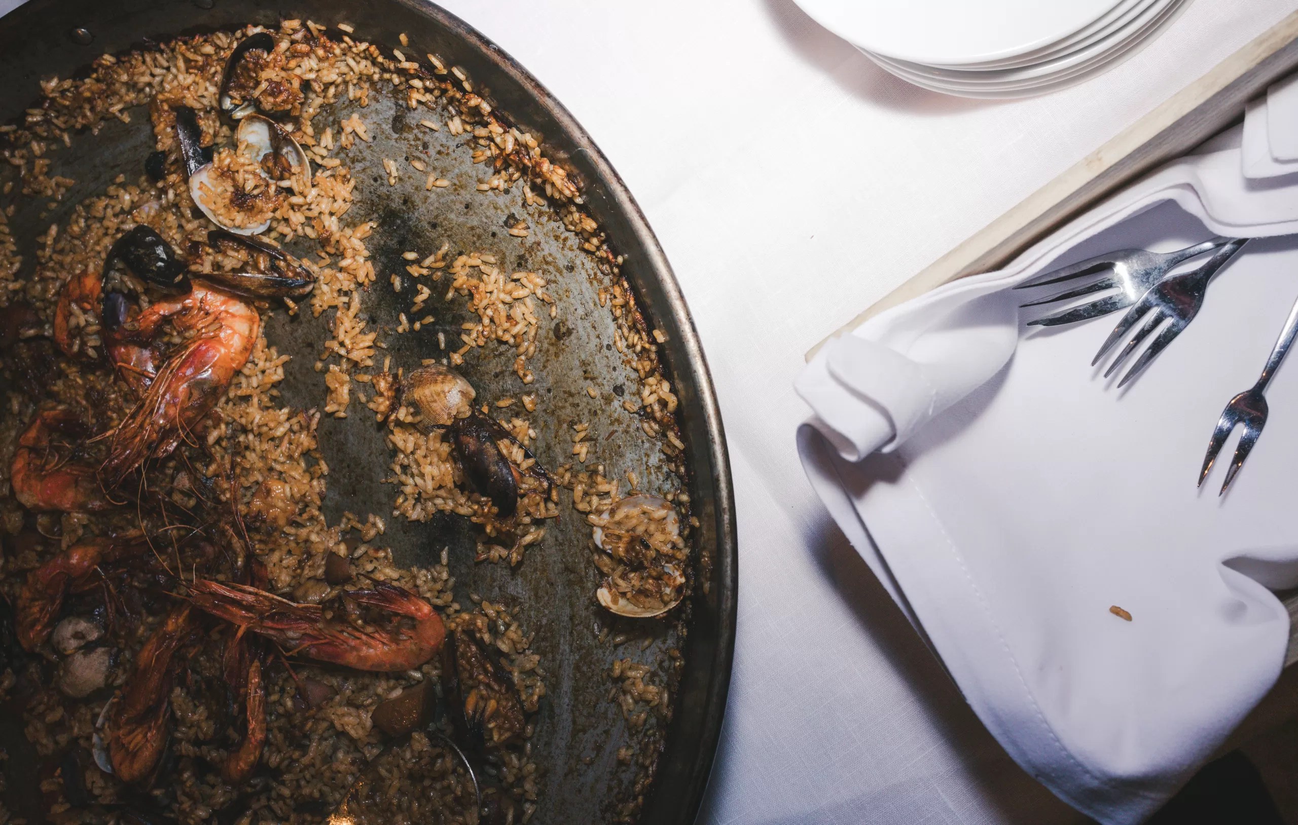 Traditional seafood paella served at Red Fish restaurant in Barcelona photographed for hospitality marketing.