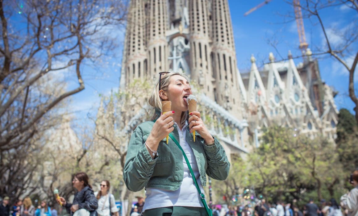 Polish woman enjoying ice cream at the front of Sagrada Familia