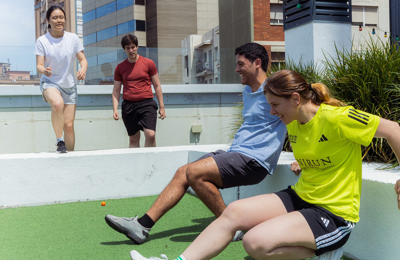 Students taking part in a Formula 1-inspired fitness challenge during Yugo Barcelona's rooftop event for Formula 1 Week, photographed by Barcelona event photographer Magdalena Bee.