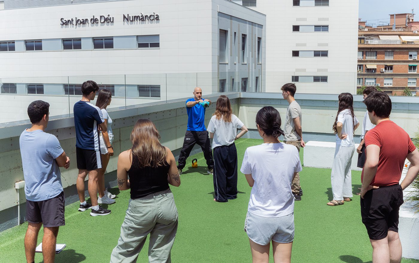 Students taking part in a Formula 1-inspired fitness training session on the rooftop of Yugo Barcelona during Formula 1 Week, photographed by Barcelona event photographer Magdalena Bee.