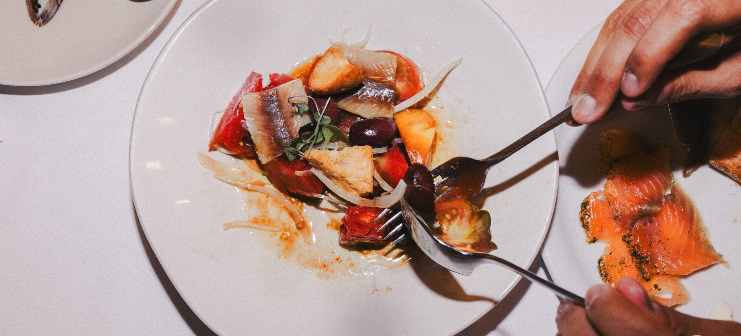 Mediterranean seafood salad with anchovies, tomatoes, olives and fresh vegetables served at Barceloneta Restaurant in Barcelona.