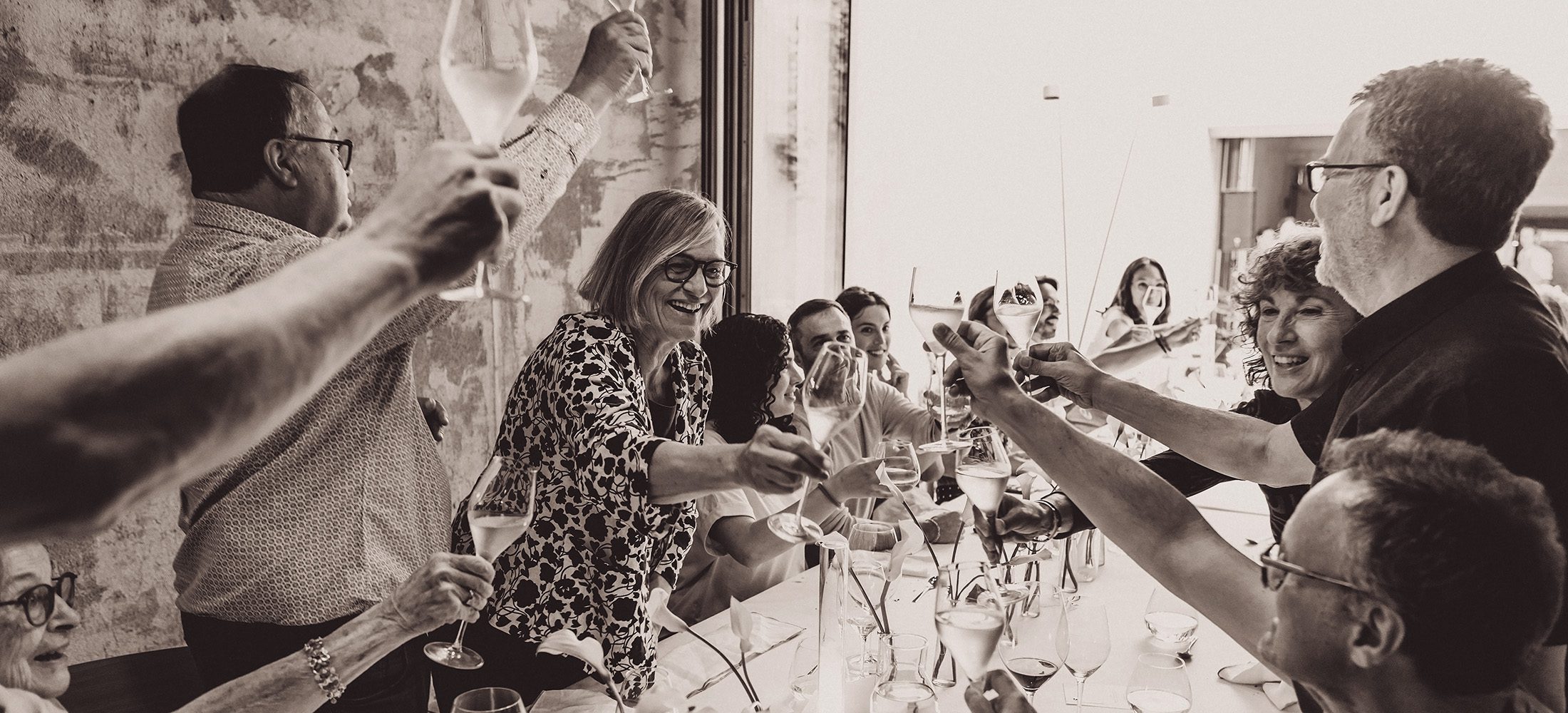 Guests raising glasses during a private 70th birthday celebration at Mimas in Granollers.