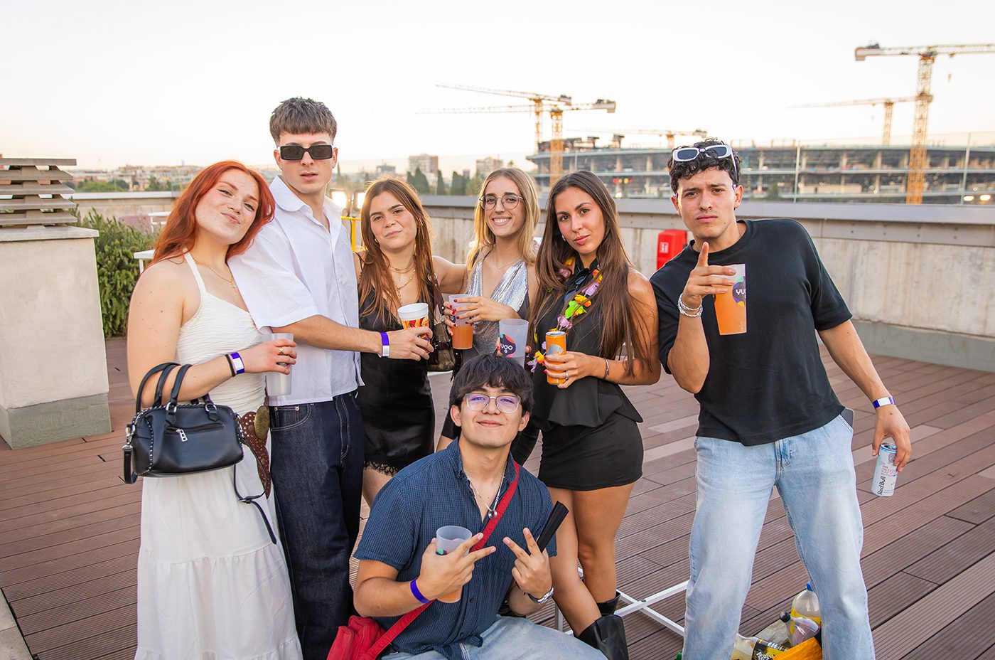 Group of university students enjoying Yugo's rooftop Formula 1 Week farewell party in Barcelona at sunset, photographed by Barcelona event photographer Magdalena Bee.