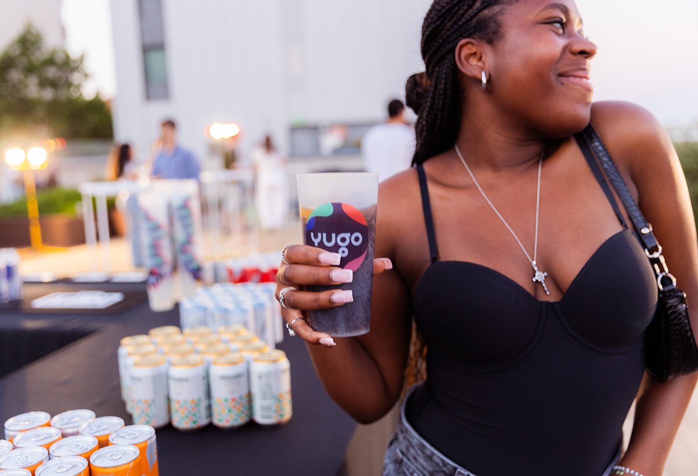 Student enjoying a drink during Yugo's Final Lap Farewell rooftop party in Barcelona as part of Formula 1 Week, photographed by Barcelona event photographer Magdalena Bee.