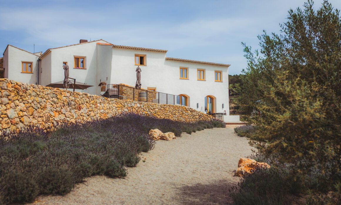 Masia Cabellut vineyard estate in Tarragona surrounded by lavender gardens, stone walls and Mediterranean countryside.